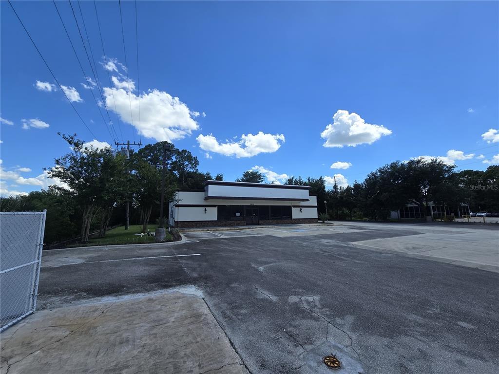 A single-story commercial building with a parking lot under a blue sky — 8801 20TH STREET, VERO BEACH, FL