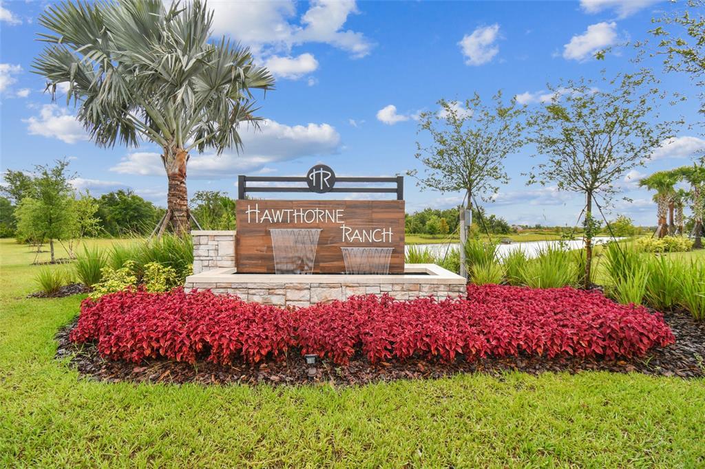 A stone and wood monument sign for Hawthorne Ranch sits in a landscaped garden — 4997 BASSWOOD STREET, LAKELAND, FL