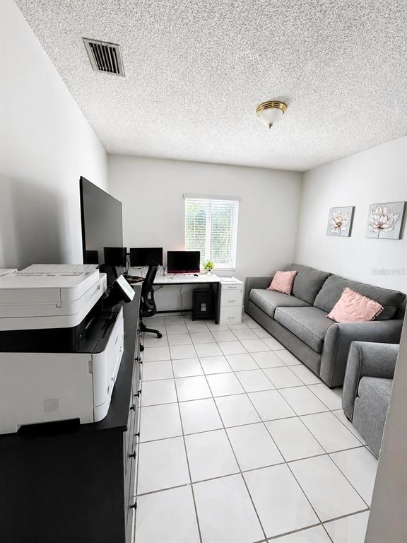 A home office with a desk, computer monitors, a printer, and a gray sofa — 20890 SW 236TH STREET, HOMESTEAD, FL