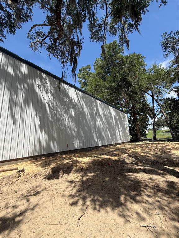 An expansive, empty industrial warehouse space features a concrete floor and metal wall panels — 12142 SE COUNTY 484 HIGHWAY, BELLEVIEW, FL