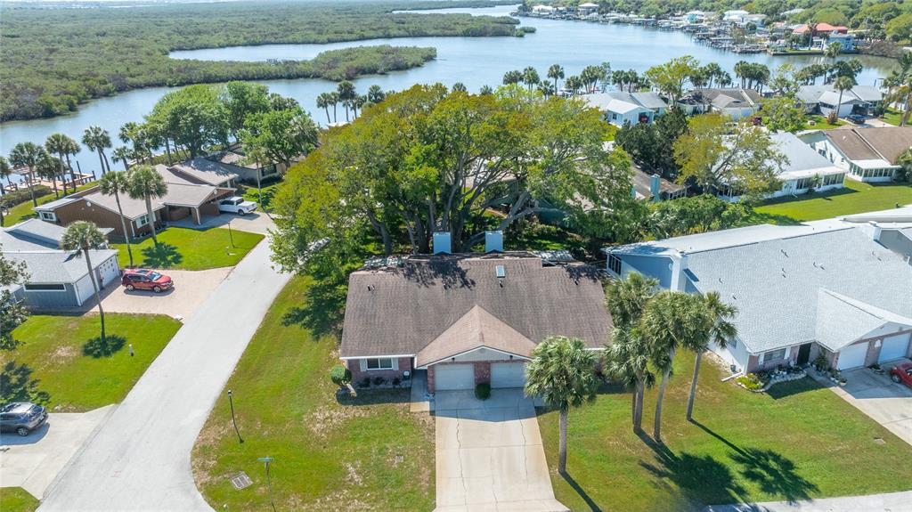 A single-story brick house with a two-car garage and a gray SUV in the driveway — 1402 PORTOBELLO DRIVE, PORT ORANGE, FL