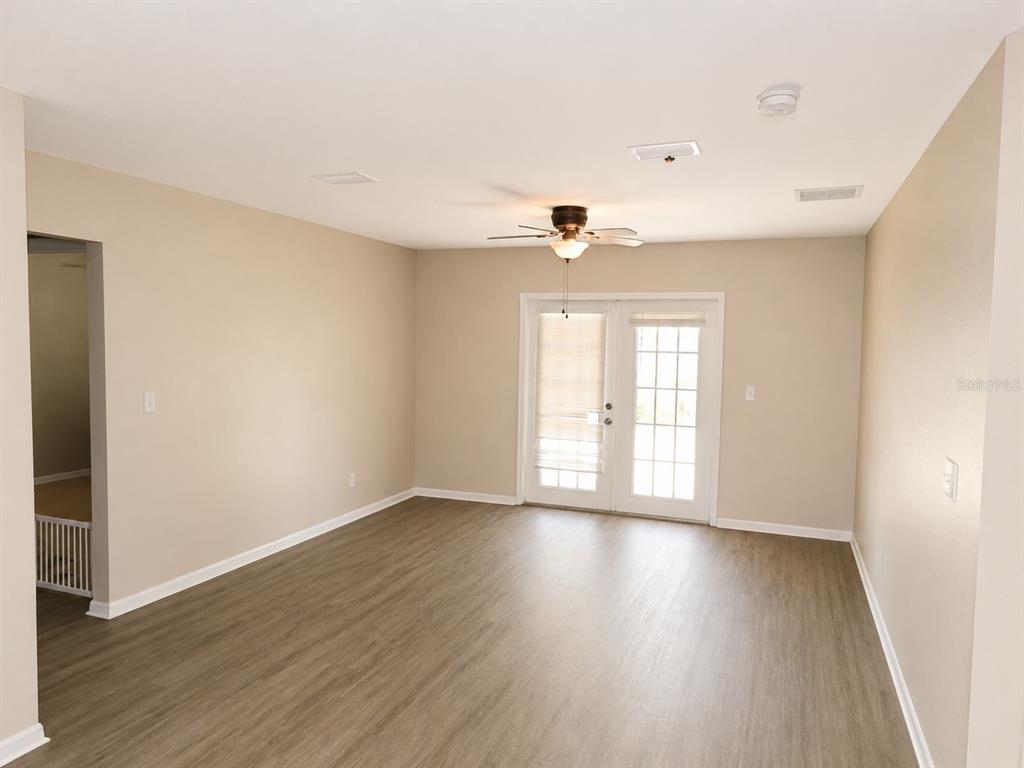 A home office features a desk, a green bookshelf, and a window with blinds — 901 SW PECAN STREET, KEYSTONE HEIGHTS, FL
