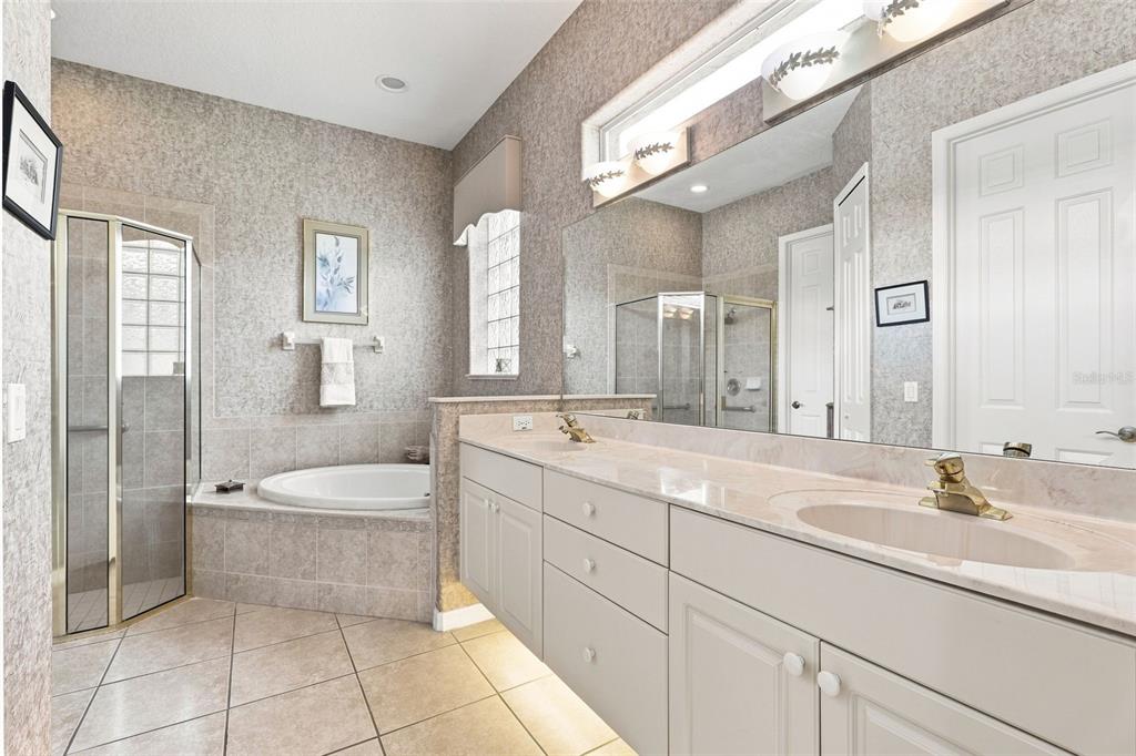 A kitchen with white cabinets, black appliances, light countertops, and a breakfast nook with windows — 437 SOTHEBY WAY, DEBARY, FL