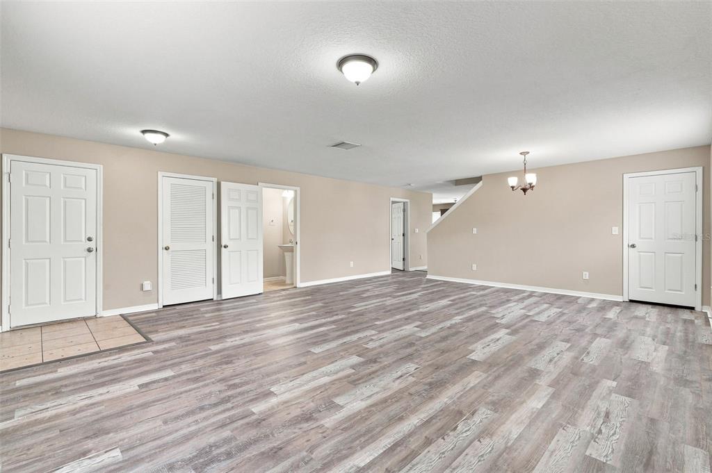 A child's bedroom features a white bed, a small table with chairs, and toy storage — 5123 CELLO WOOD LANE, WESLEY CHAPEL, FL