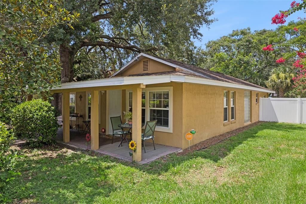 A tan stucco house with a covered front porch and a small patio set — 2109 E GRANT AVENUE, ORLANDO, FL