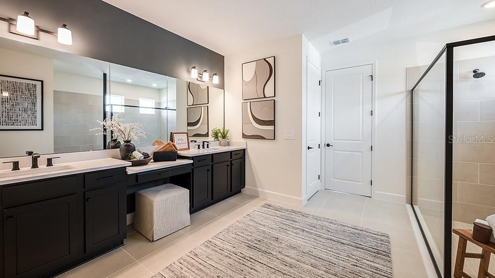 A dining area and kitchen feature a wooden table, black island, and white cabinetry — 5412 GUNWALE DRIVE, COCOA, FL