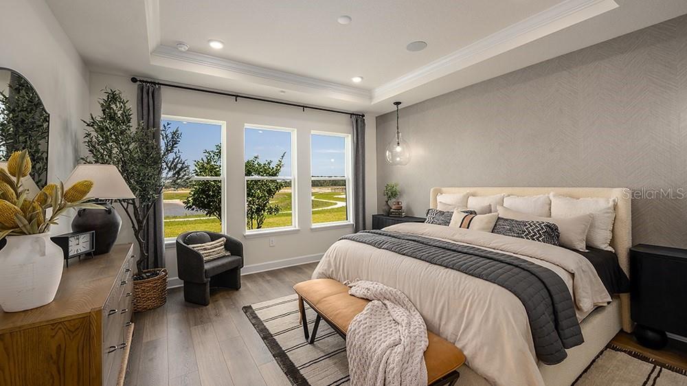 A bright living room features a curved sofa, round coffee table, and large sliding glass doors — 5412 GUNWALE DRIVE, COCOA, FL