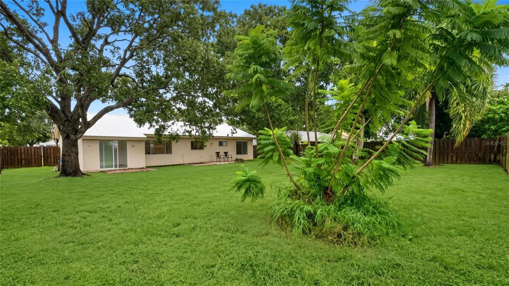 A room with a white front door, a large window, and two different tile floors — 731 SW 24TH STREET, VERO BEACH, FL