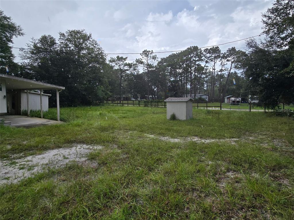 A kitchen features white cabinets, a white stove, a white refrigerator, and blue walls — 7810 W TWIN CANAL LANE, HOMOSASSA, FL