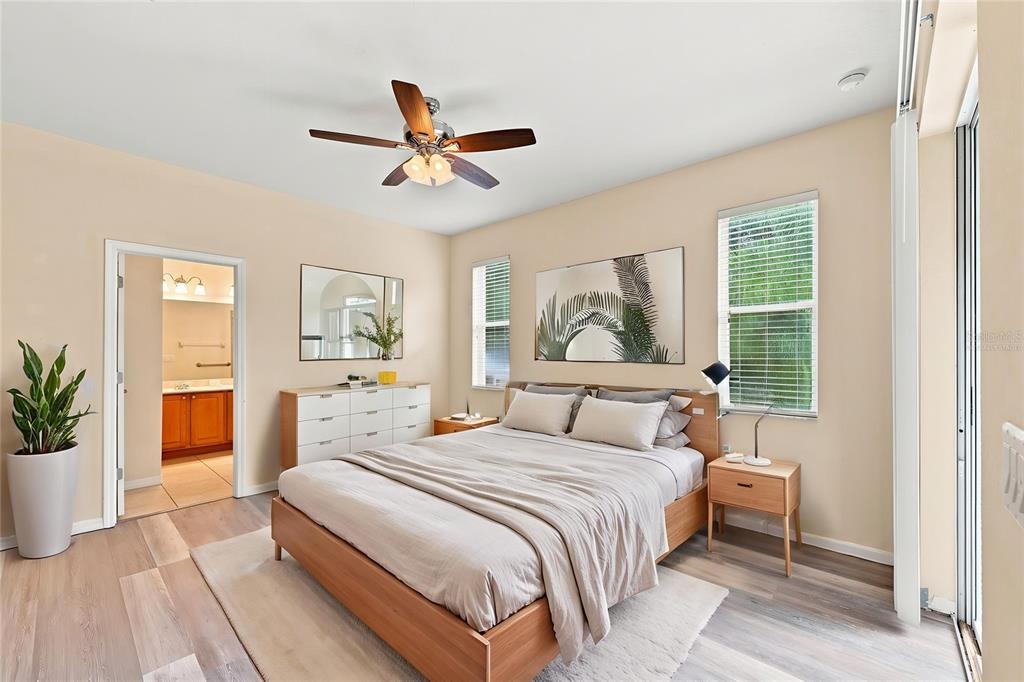 A bedroom features a wooden bed frame, a white dresser, and a ceiling fan — 4469 STONEY RIVER DRIVE, MULBERRY, FL