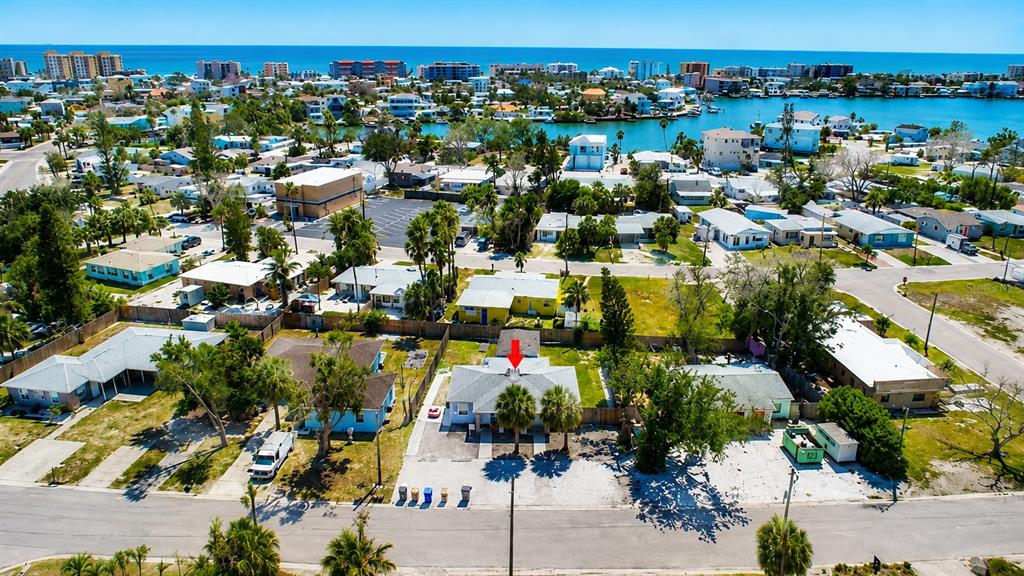 An aerial view shows a residential neighborhood with a house marked by a red arrow — 14026 E PARSLEY DRIVE, MADEIRA BEACH, FL