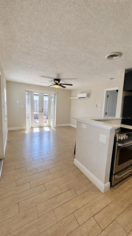 A galley kitchen features granite countertops, dark wood cabinets, stainless steel appliances, and tile flooring — 14026 E PARSLEY DRIVE, MADEIRA BEACH, FL