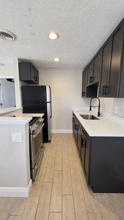 A kitchen features dark wood cabinets, granite countertops, and a multi-colored tile backsplash — 14026 E PARSLEY DRIVE, MADEIRA BEACH, FL