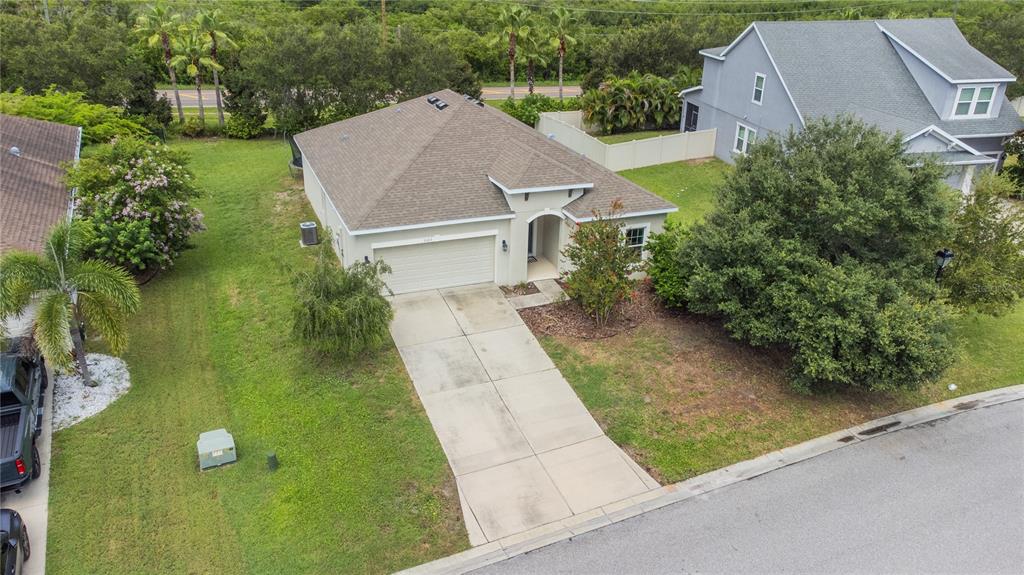 An aerial view shows a single-story house with a concrete driveway and a grassy yard — 3123 MELA COURT, HOLIDAY, FL