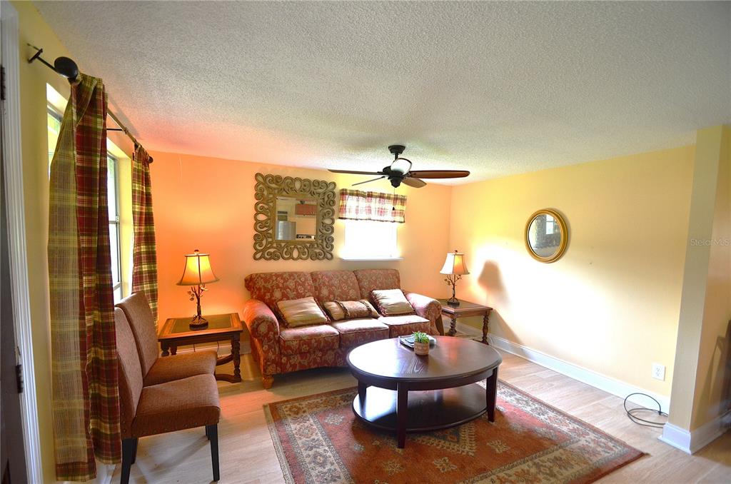 A living room features a floral sofa, a round coffee table, and a patterned area rug — 0 SE HIGHWAY 31, ARCADIA, FL