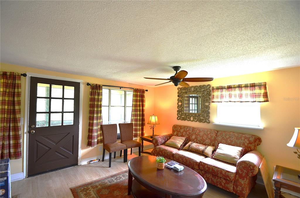 A living room features a patterned sofa, a coffee table, two chairs, and a ceiling fan — 0 SE HIGHWAY 31, ARCADIA, FL