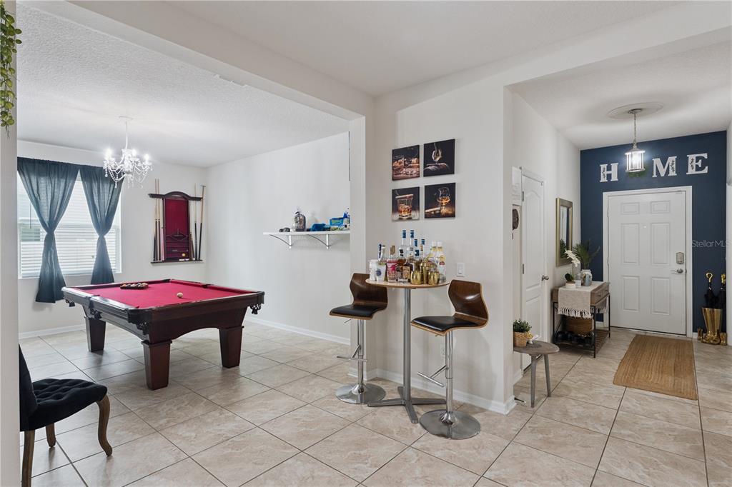 A room with a pool table, a small bar area, and an entryway with a door — 637 BAY BRIDGE CIRCLE, APOPKA, FL