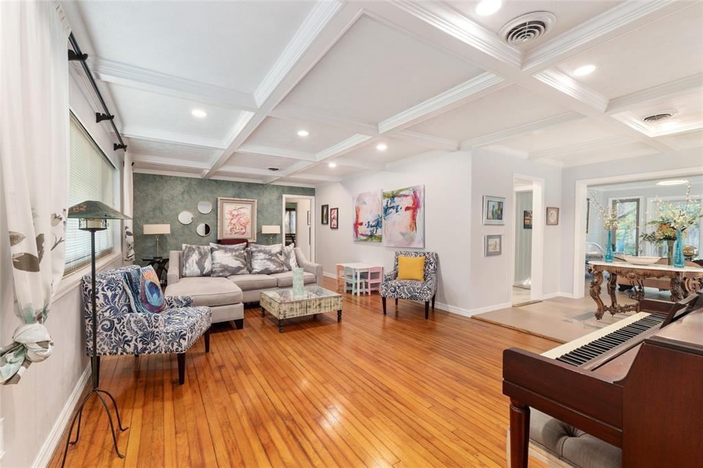A living room features a coffered ceiling, hardwood floors, a sectional sofa, and a piano — 1210 SE 14TH AVENUE, OCALA, FL