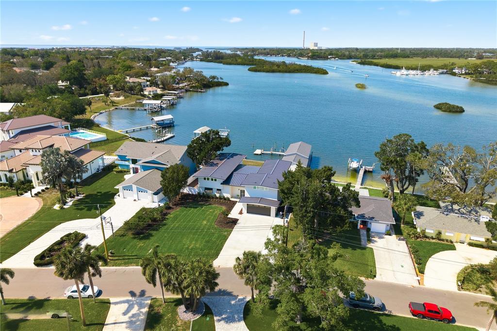 An aerial view shows a waterfront residential property with a private dock and boat lift — 915 BAYSHORE DRIVE, TARPON SPRINGS, FL