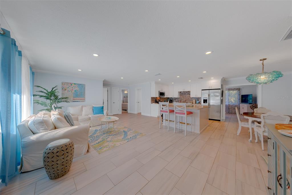 A living room with two white sofas, a coffee table, and a front door — 196 OVERBROOK DRIVE E, LARGO, FL