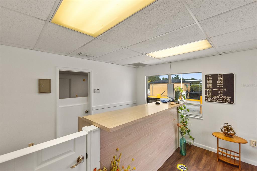 A reception area features a light wood counter, white walls, and a price list sign — 5550 15TH STREET E, BRADENTON, FL