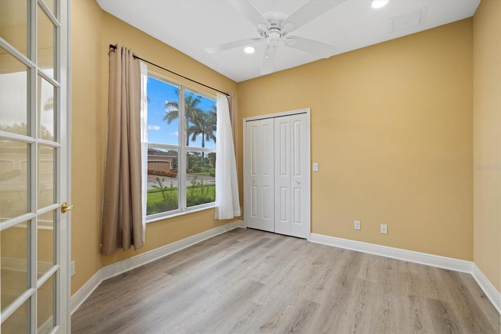 An empty room with light-colored walls, wood-look flooring, a ceiling fan, and a closet — 4331 TURNBERRY CIRCLE, NORTH PORT, FL