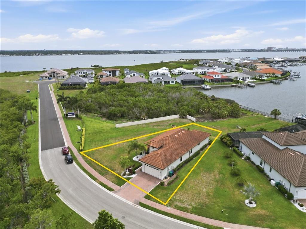 An aerial view shows a single-story house with a tiled roof on a corner lot — 2317 5TH STREET E, PALMETTO, FL