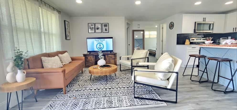 A single-story house with a white and black stone exterior, a driveway, and a garage — 4012 VALENCIA DRIVE, NEW PORT RICHEY, FL