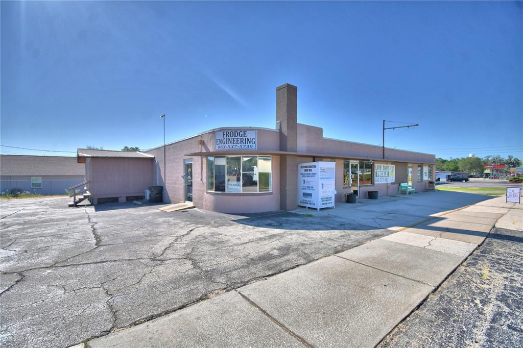 A single-story commercial building with a donation sign and a live bait and tackle shop — 105 S SCENIC HIGHWAY, FROSTPROOF, FL