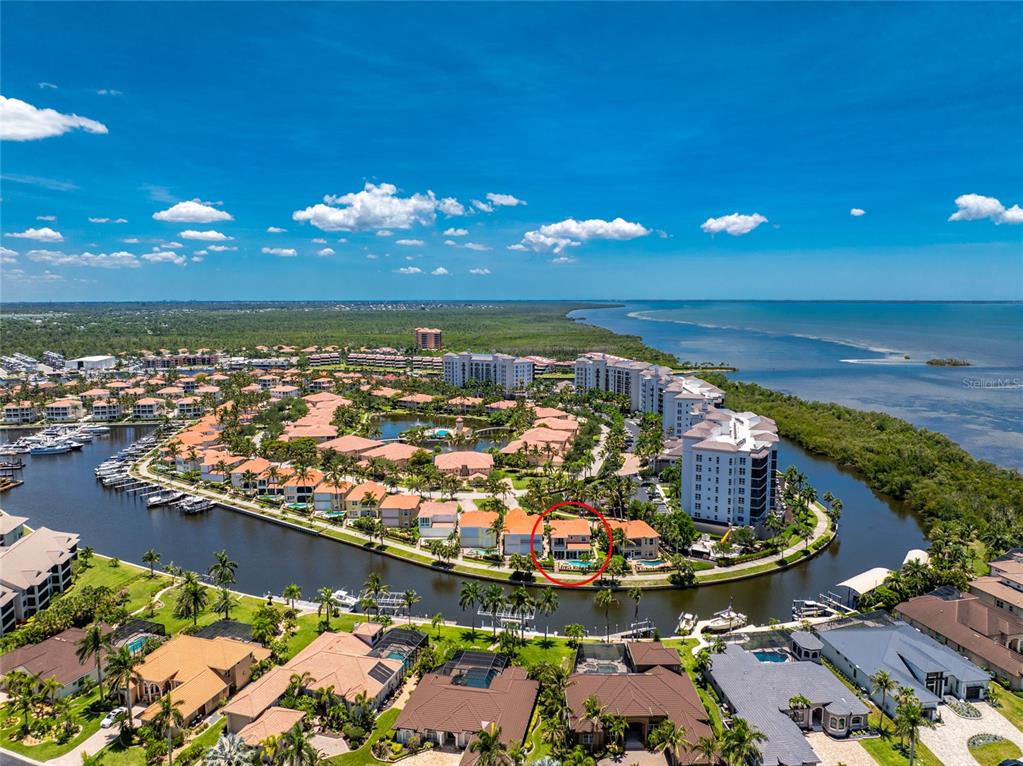An aerial view shows a waterfront residential community with a red circle highlighting a house — 3341 SUNSET KEY CIRCLE, PUNTA GORDA, FL