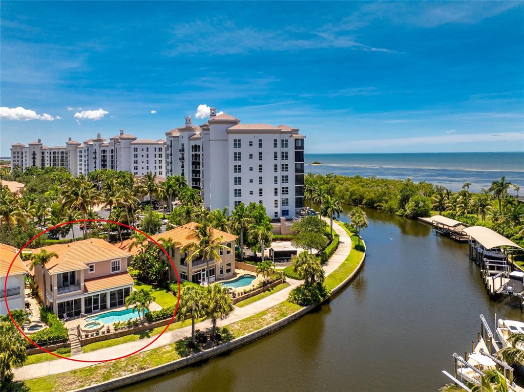 An aerial view shows a two-story house with a pool and patio along a canal — 3341 SUNSET KEY CIRCLE, PUNTA GORDA, FL