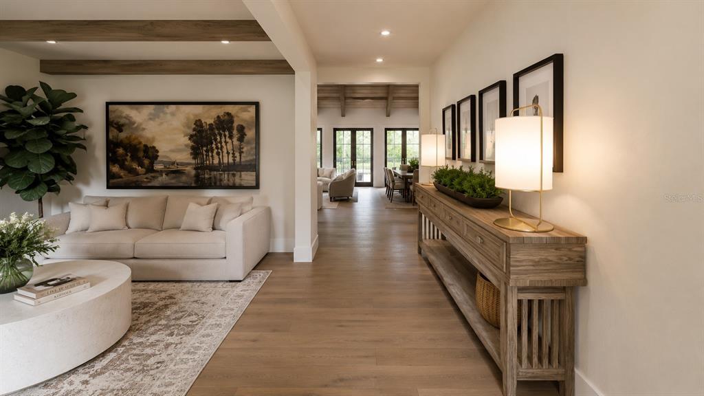 A living room with a beige sofa and a wooden console table leads to a dining area — 0000 ALLVIEW DRIVE, TAMPA, FL
