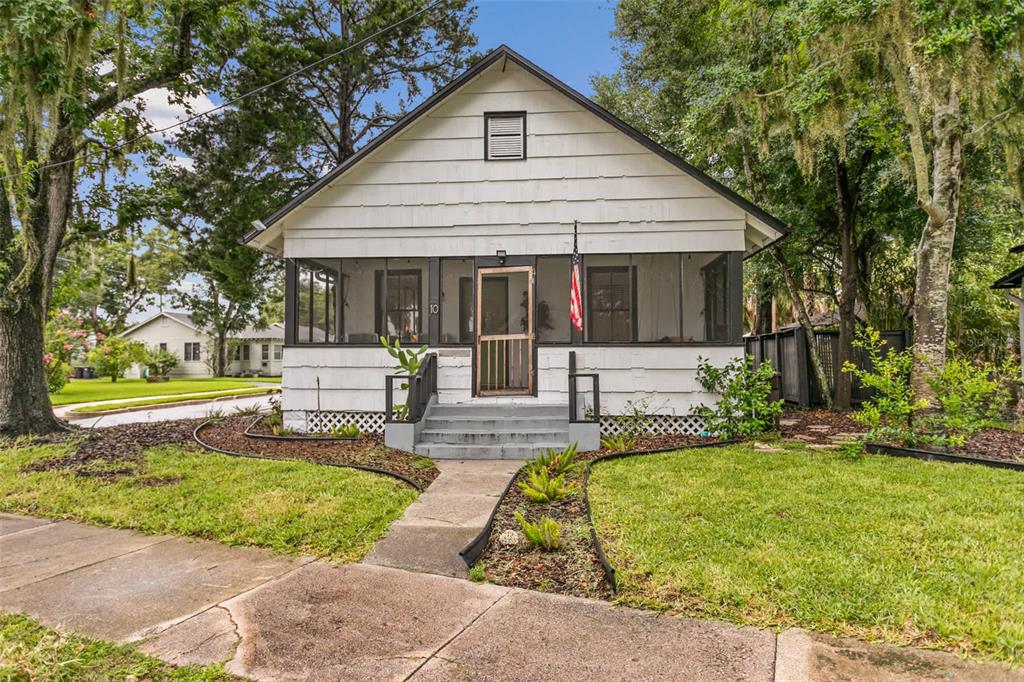 A white, single-story house with a screened-in front porch and a concrete walkway — 10 PACIFIC STREET, ST AUGUSTINE, FL