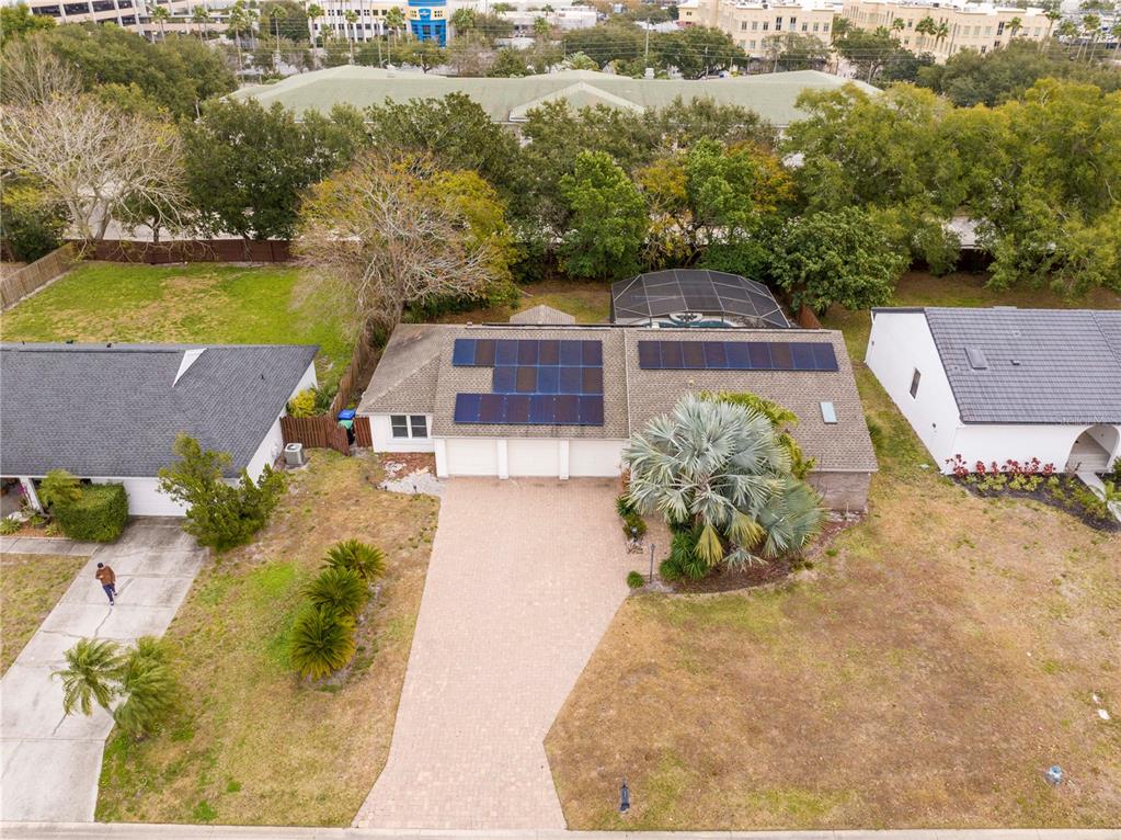 An aerial view shows a single-story house with solar panels and a paved driveway — 6013 CRYSTAL VIEW DRIVE, ORLANDO, FL
