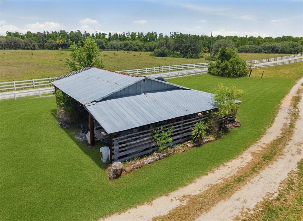 An aerial view shows a rural property with a house, outbuilding, and driveway outlined in red — 7242 BLACK ROAD, LAKE WALES, FL