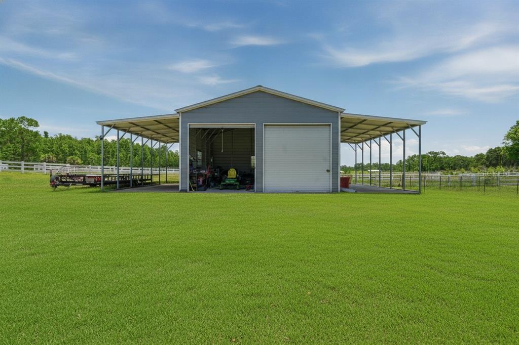 An aerial view shows a weathered barn with a metal roof on a grassy lot — 7242 BLACK ROAD, LAKE WALES, FL