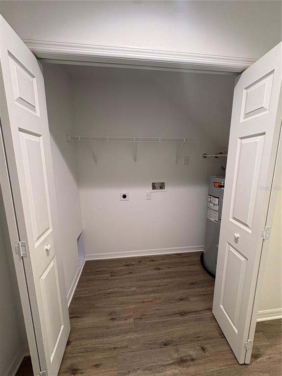 A laundry closet with a water heater, wire shelving, and wood-look flooring — 2525 6TH AVENUE DRIVE E, BRADENTON, FL