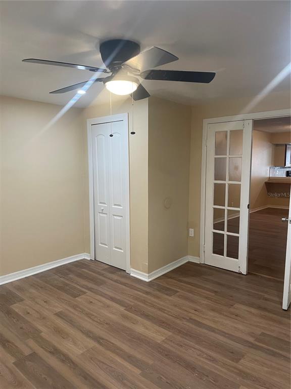 A room with wood-look flooring, a ceiling fan, a closet, and French doors — 5565 N CABOT DRIVE, JACKSONVILLE, FL