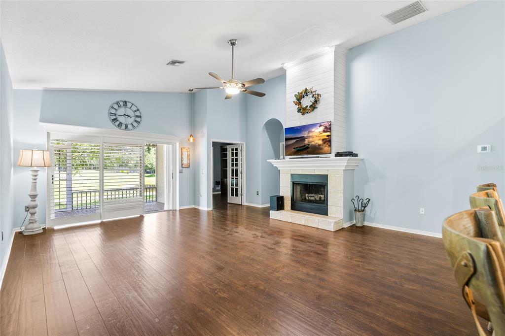A kitchen features white cabinets, stainless steel appliances, a wood range hood, and white countertops — 19218 SEA MIST LANE, LUTZ, FL