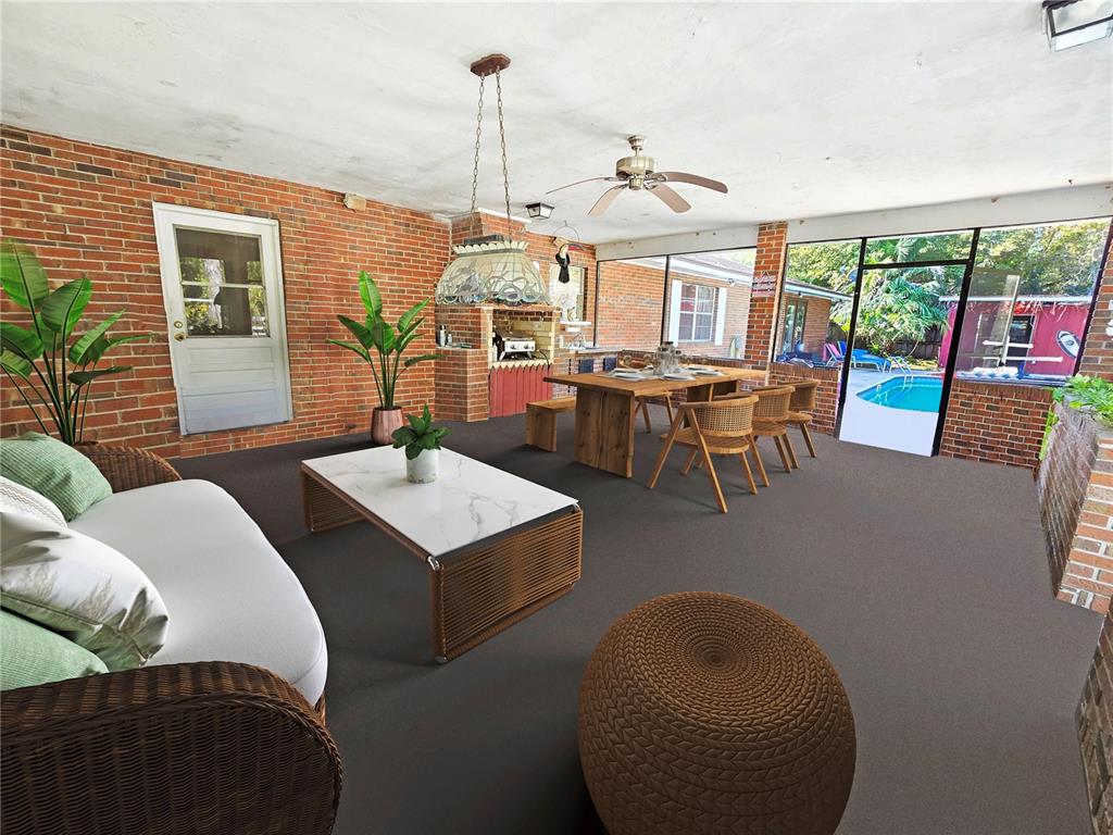 A covered brick patio features a dining area, a seating area, and a swimming pool view — 12046 US-301, HAMPTON, FL