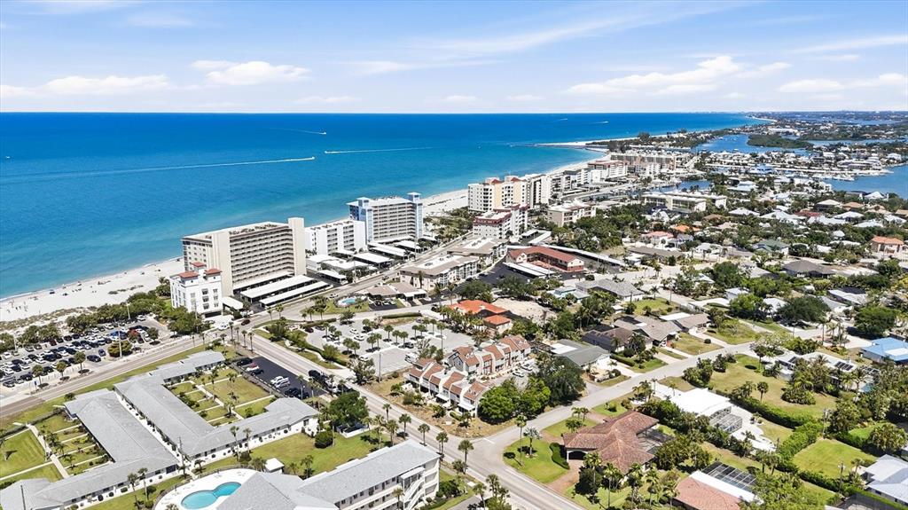 An aerial view shows a coastal town with high-rise beachfront condos and residential neighborhoods — 744 CADIZ ROAD UNIT 8, VENICE, FL