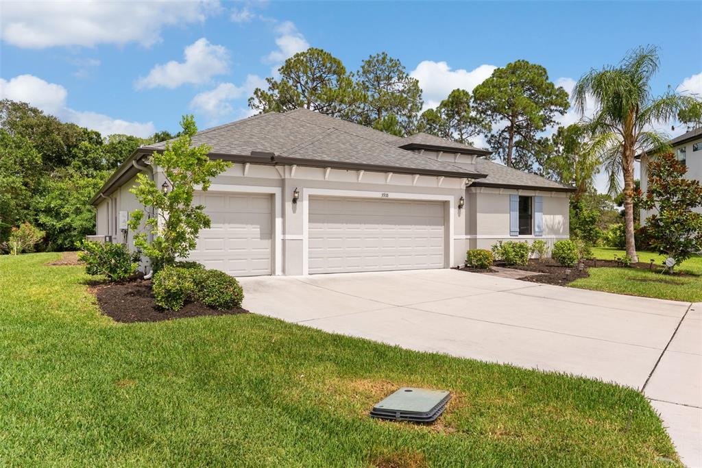 A single-story house with a two-car garage and a concrete driveway on a grassy lot — 3918 GAVIOTA DRIVE, RUSKIN, FL
