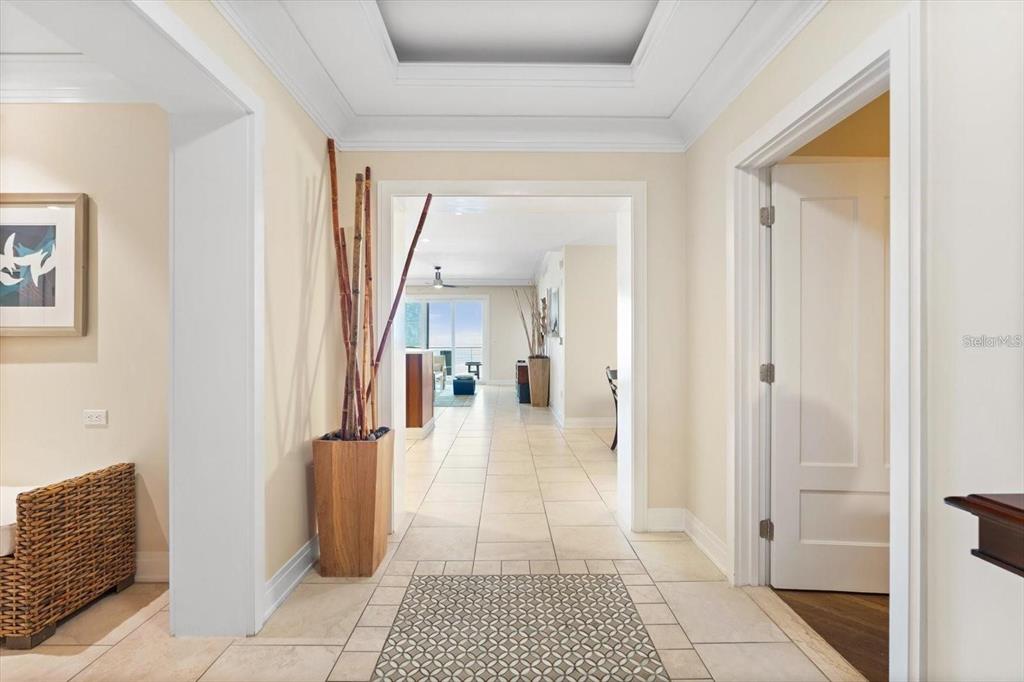 A tiled foyer leads through an arched doorway into a bright, open-concept living space — 915 SEASIDE DR UNIT 405, WEEKS 22-23, SARASOTA, FL