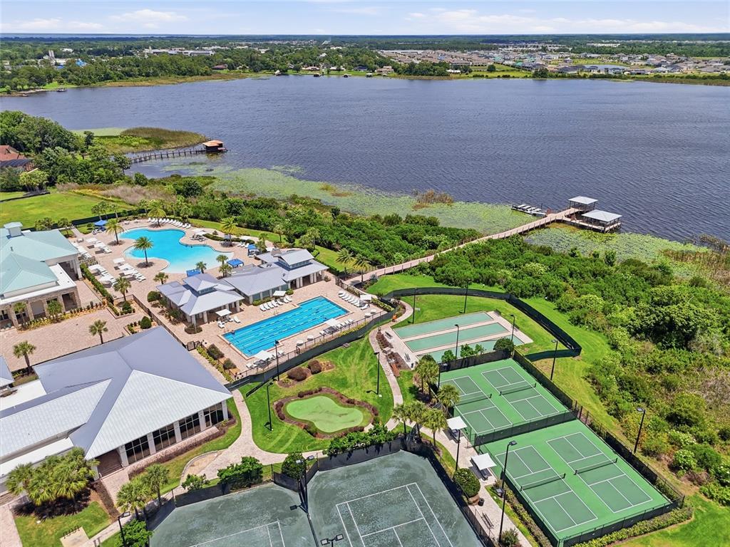 A covered outdoor patio features wicker furniture, a dining table, and a paved floor — 2486 DATURA LOOP, ST CLOUD, FL