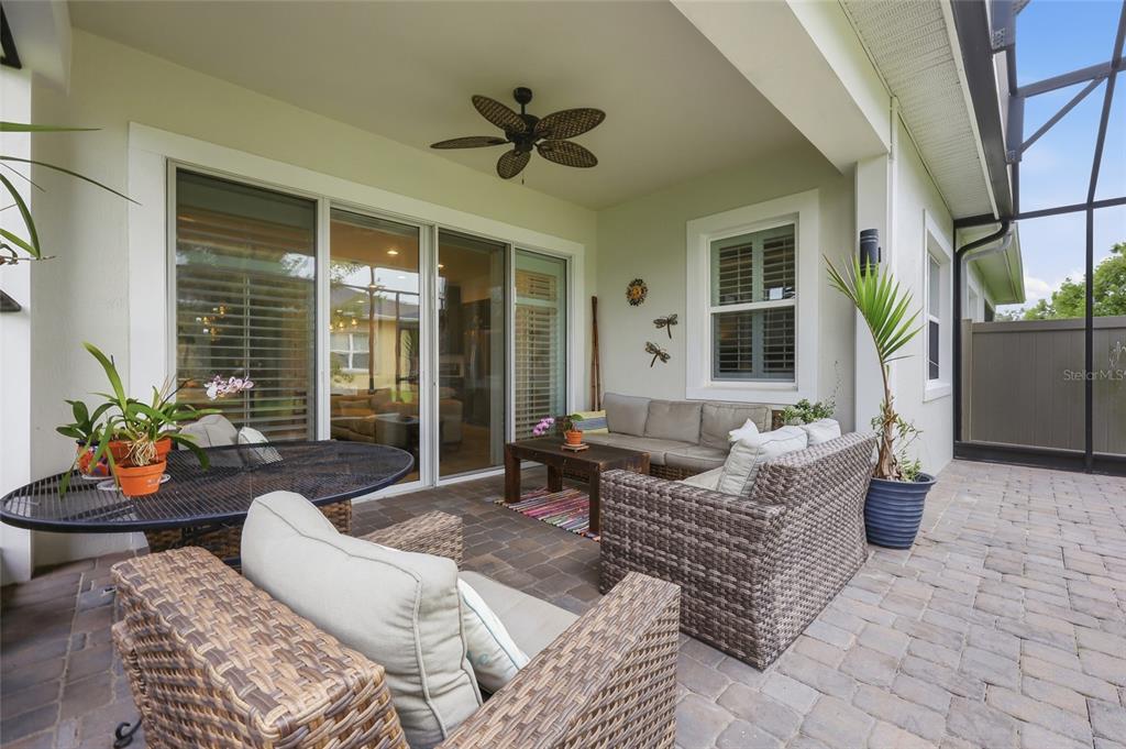 An aerial view shows a community clubhouse with swimming pools, tennis courts, and a lake — 2486 DATURA LOOP, ST CLOUD, FL