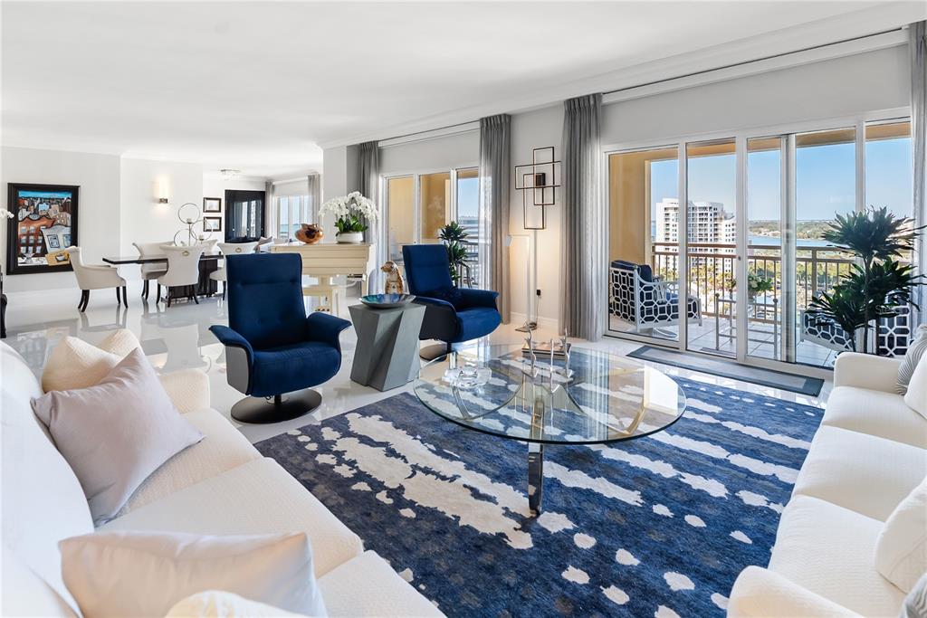 A bright living room features white tile floors, a grand piano, and floor-to-ceiling windows — 1111 RITZ CARLTON DRIVE UNIT 1603, SARASOTA, FL