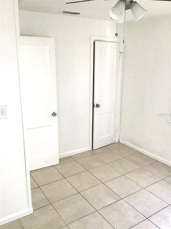 A room with white walls, tiled flooring, and two closed white doors — 2226 27TH STREET S, ST PETERSBURG, FL