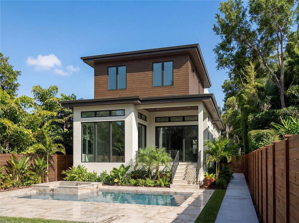 A two-story modern house with a swimming pool, patio, and wooden fence in the backyard — 4183 ROBERTS POINT CIRCLE LOT 18, SARASOTA, FL