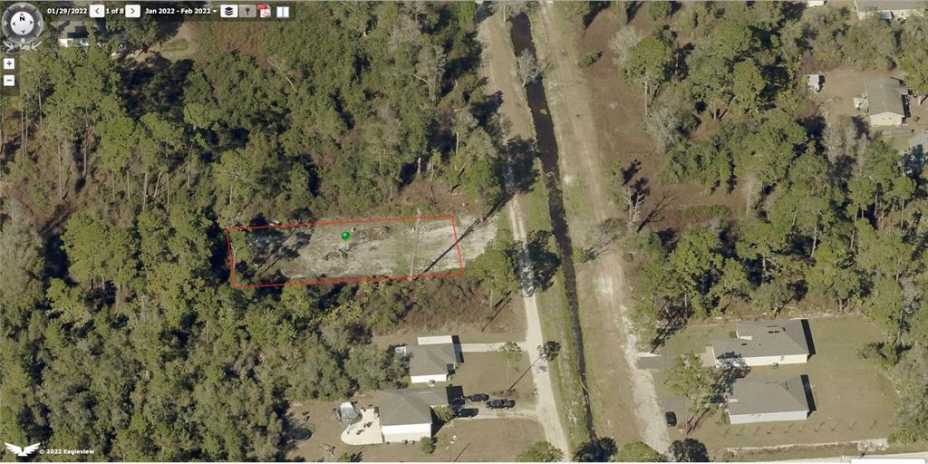 An aerial view shows a rectangular cleared lot surrounded by trees next to a canal — 0 CENTRAL PARKWAY, DELAND, FL