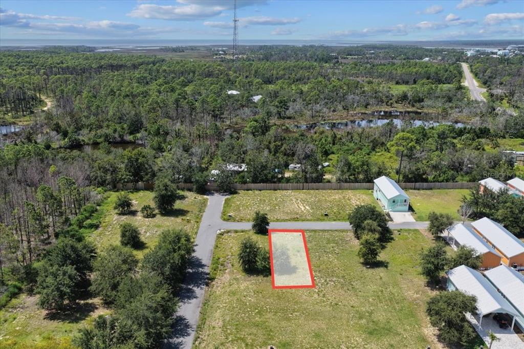 An aerial view shows a rectangular plot of land outlined in red near a road — 000 869TH LOOP, STEINHATCHEE, FL